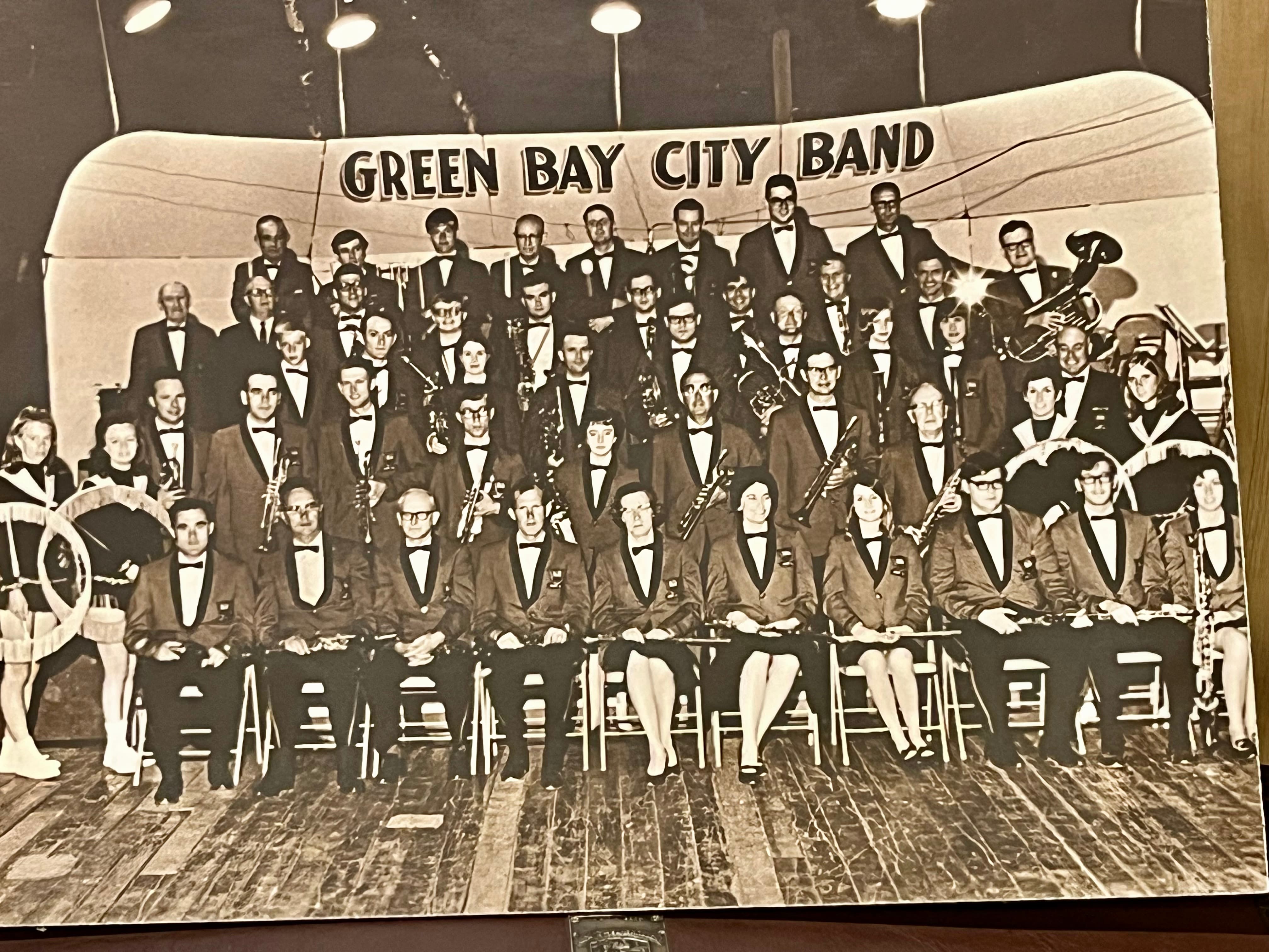 A black and white group photo of the 1969 Green Bay City Band posed on risers.