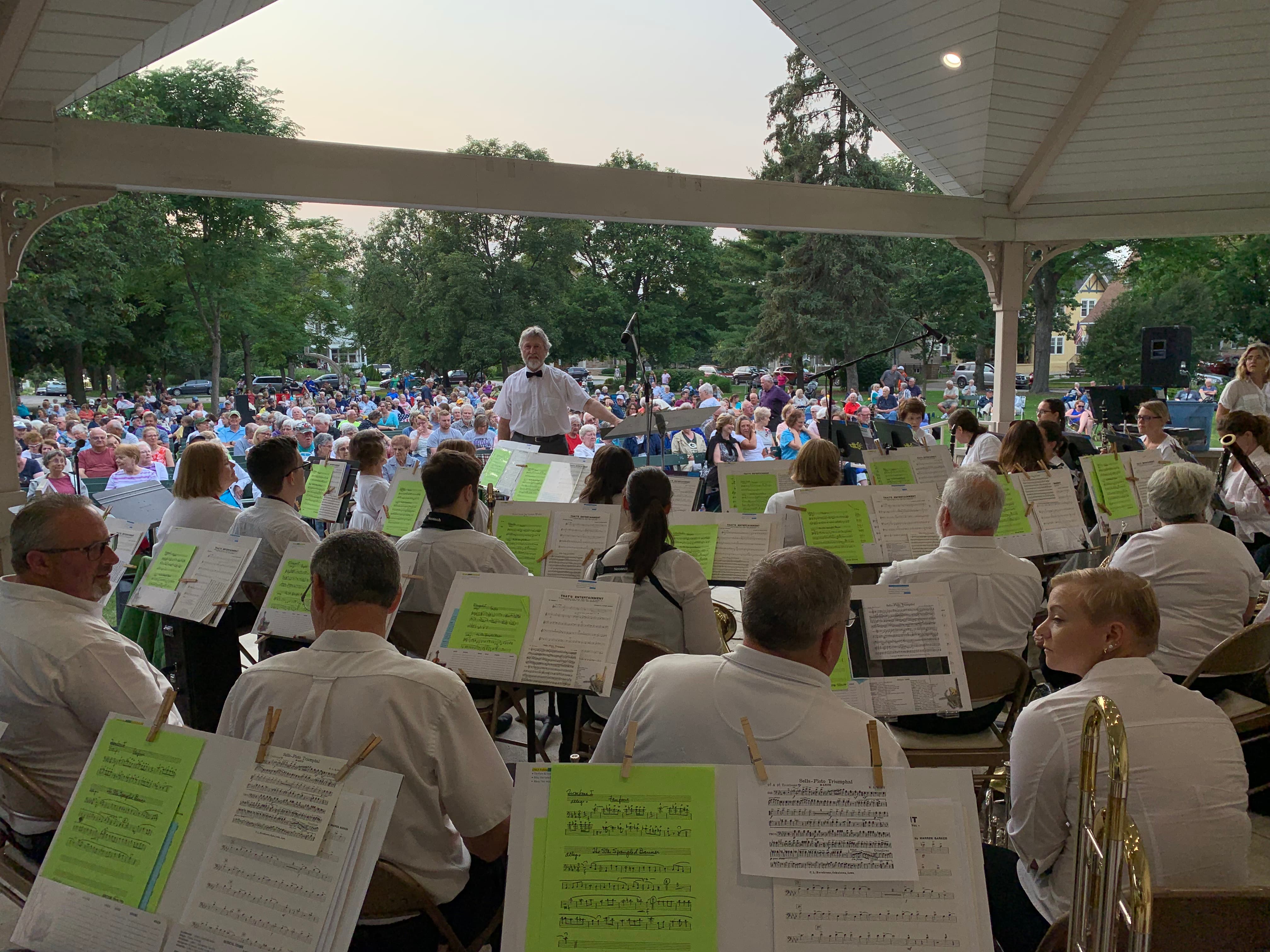 A large crowd enjoying a Green Bay City Band outdoor concert at St. James Park