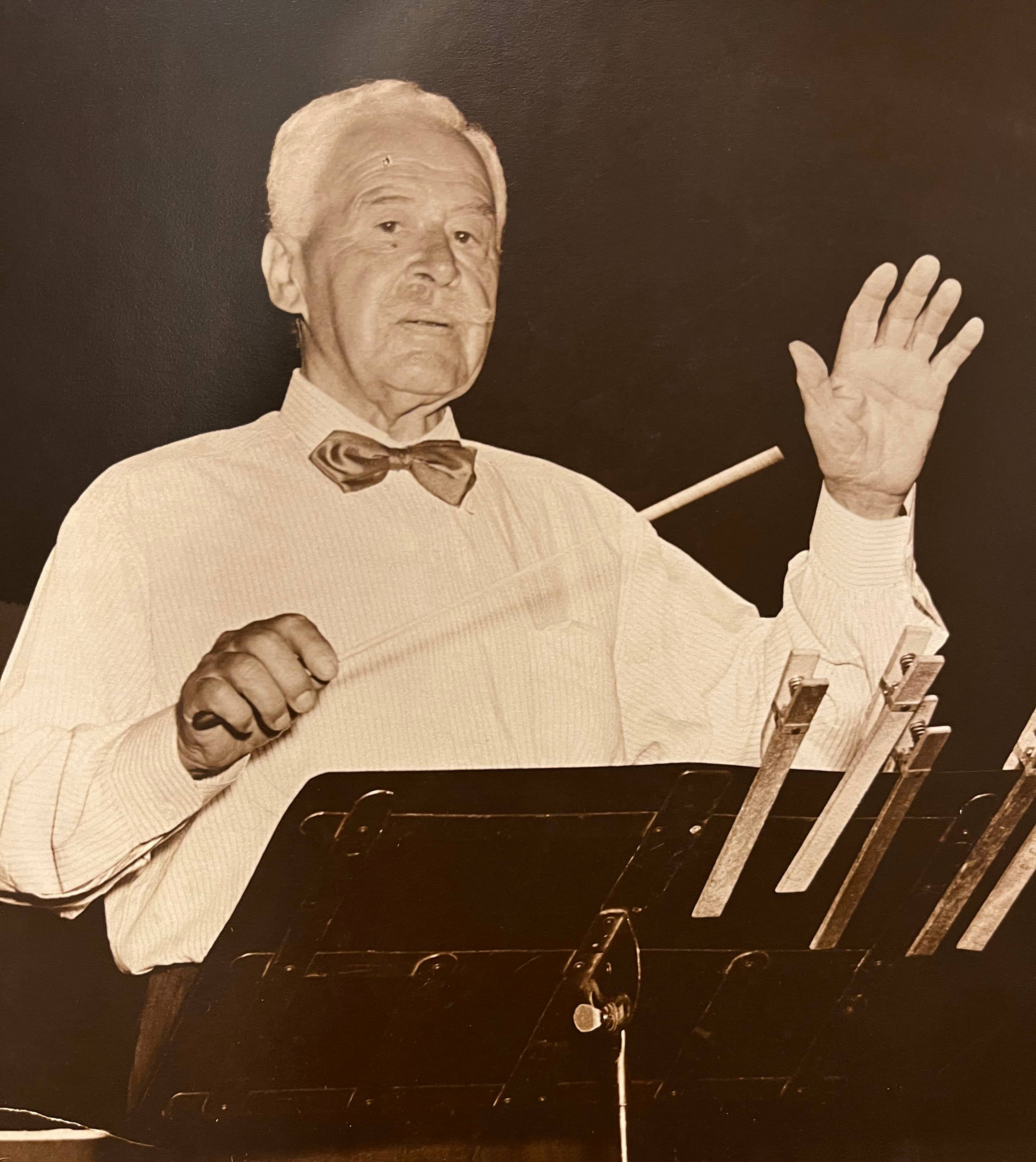 Ernest W. Stiller looking into the camera while conducting